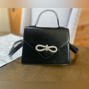 Faux leather crossbody bag. Rhinestone bow !